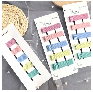 Detail view of colorful metal hairpins set in pastel candy colors on a display card