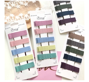 Set of 40 colorful matte bobby pins neatly organized on four white display cards