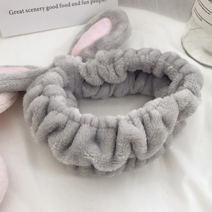 Cute gray plush bunny ear headband made of soft coral fleece for skincare and makeup routines