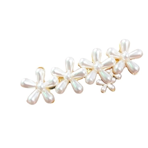 Elegant pearl flower hair clip with six white floral motifs on a gold metal base