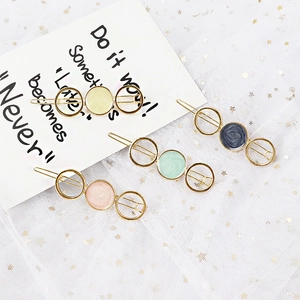 Set of four minimalist gold star-patterned geometric hair clips with colorful enamel finish