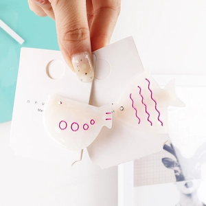 Cute dolphin-shaped acetate hair clips with shimmering pearlescent finish and rhinestones