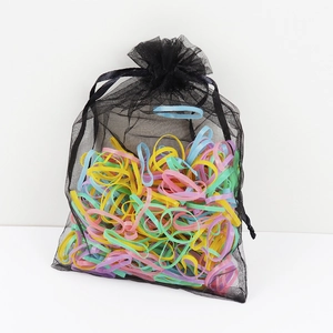 Colorful elastic hair bands set stored in a black mesh drawstring pouch for children