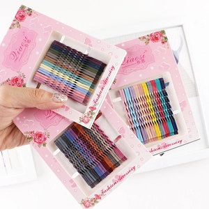 Set of 10 colorful metal bobby pins with wavy design on a pink floral card