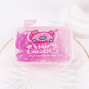 Close-up of pink elastic hair bands in a cute storage box with cartoon pig card
