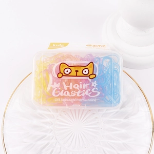 Close-up of colorful candy-colored hair elastics organized in a transparent cat-themed box