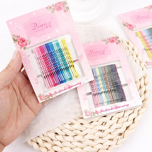 Close-up of colorful wave-shaped bobby pins set in rainbow and Morandi tones