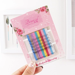 Colorful wave bobby pins set neatly arranged on decorative floral packaging card