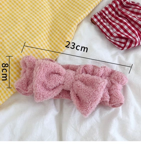 Detail view of pink coral fleece headband with bow showing 23cm length and 8cm width