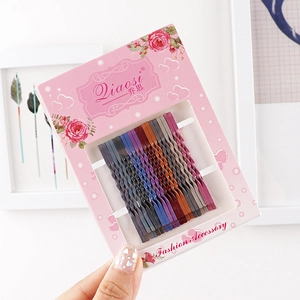 Detailed view of colorful metal bobby pin set in assorted Morandi colors on pink card