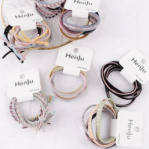 Braided hair ties set in various colors with text prints on textured background