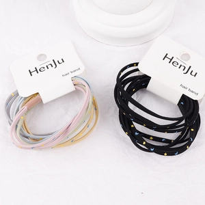 Set of elastic hair ties with star and moon patterns on original brand packaging cards