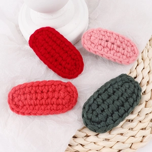 Handmade chunky wool knitted hair clips in red and green for a vintage forest style look