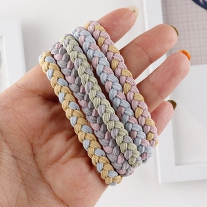 Close-up of four colorful braided hair ties with thick elastic texture in Macaron pastel colors