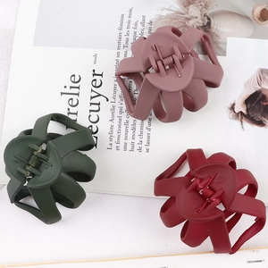 Three matte colored hair claws in green, pink and red for daily hairstyling