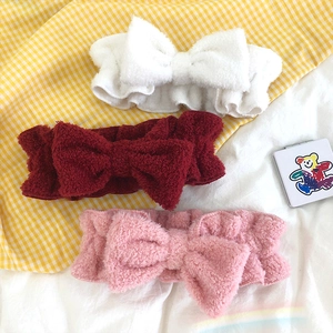 Soft bow headbands in white, burgundy, and pink shown on checkered fabric background