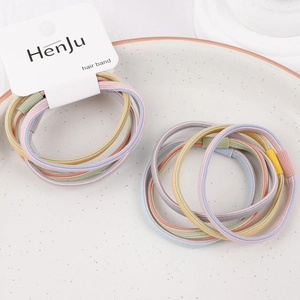Close-up of colorful braided elastic hair bands in pastel macaron tones with plastic clasps