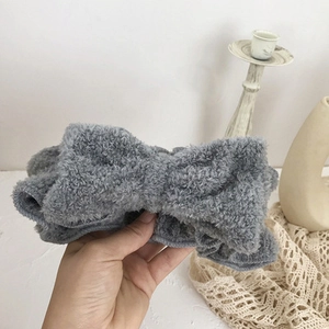 Detailed view of the soft grey plush bow headband made from premium coral fleece fabric