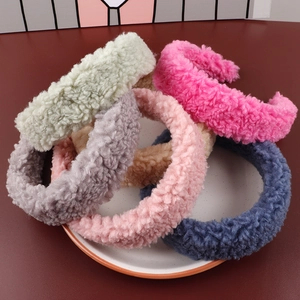 Macro view of lamb wool headbands in mint, pink, and grey with plush texture