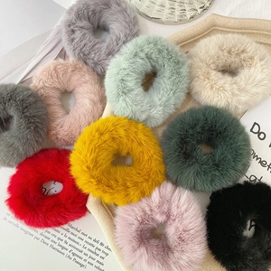 Plush faux rabbit fur scrunchies set in various colors on a stylish decorative tray