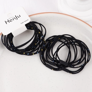 Close-up of high-elastic black hair bands featuring yellow star and blue moon patterns