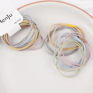 Macro view of macaron hair bands with star and moon patterns on a ceramic plate