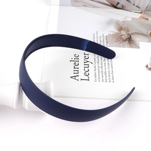 Detail of navy blue matte headband with non-slip teeth on aesthetic magazine background