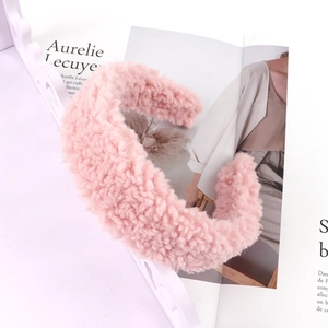 Close-up of pink faux lamb wool headband showing soft plush texture and wide design