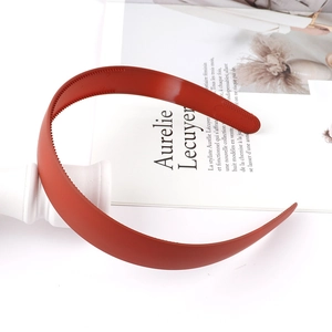 Detail view of brick red matte headband featuring inner non-slip teeth for secure styling