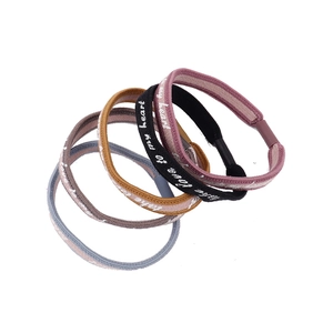 Set of 4 elastic fabric hair ties in pink, black, yellow and grey with Love print