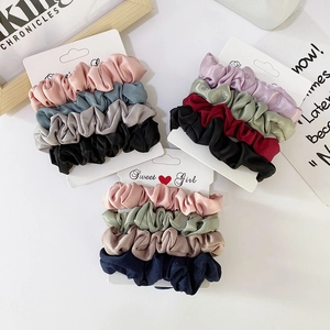 Elegant satin hair scrunchies set in various colors displayed on white cards