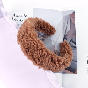 Close-up detail of warm brown lamb wool headband with plush fuzzy texture and thick wide band