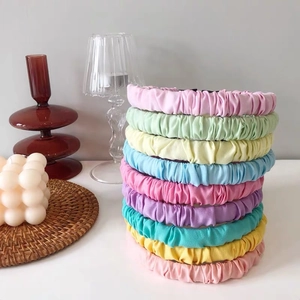 Colorful ruffled macaron fabric headbands displayed in various sweet candy colors