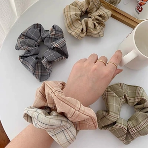 Japanese houndstooth plaid fabric scrunchies in multiple colors on a white table