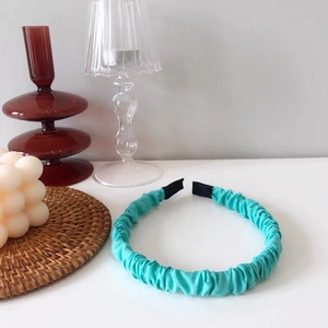 Close-up of light cyan ruched headband with soft black padded ends for comfort