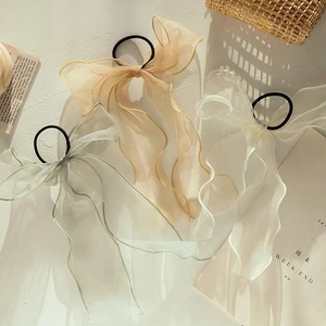 Elegant organza bow scrunchies in champagne, grey-green, and white for daily styling