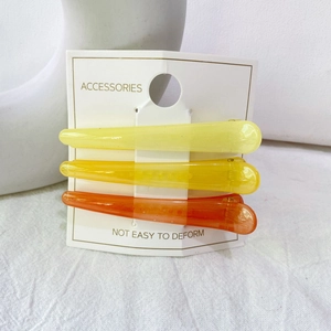 Lot de trois barrettes à dégradé de couleurs gelée jaune et orange sur leur support