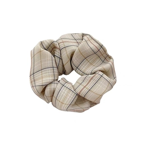 Classic houndstooth fabric scrunchie in cream and yellow plaid pattern for women