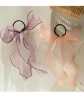 Detail of light purple and peach pink organza bow hair scrunchies with long ribbons
