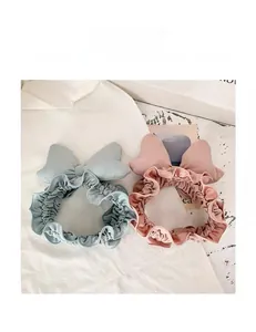 Close-up of soft bow headbands in blue and pink for face washing and makeup