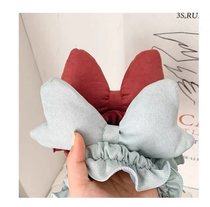Detail of red and light blue bow headbands with soft fabric texture and elastic band