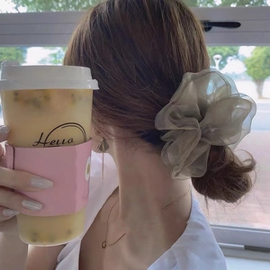Eleganter großer Organza Haargummi in Salbeigrün in einer stilvollen Außenaufnahme