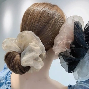 Detail von Oversize-Haargummi aus Organza mit zartem Schimmer und bauschiger Textur