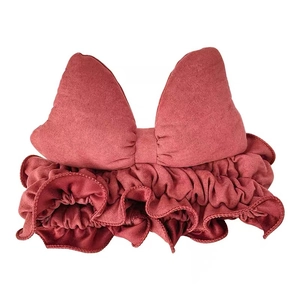 Pink elastic bow headband with large stuffed bow and ruffled edge for face washing