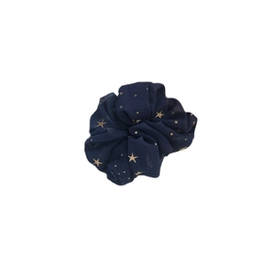 Dark blue chiffon scrunchie with gold star foil print on a plain white background