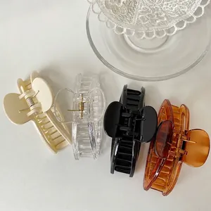Elegant large pearl claw clips in cream, clear, black and amber tones for women