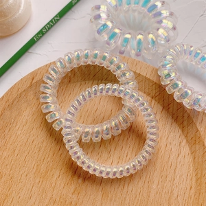 Élastiques à cheveux spirale sirène irisés sur plateau en bois, lot de quatre cordons torsadés