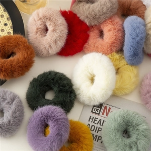 Colorful plush hair scrunchies in various pastel shades for a soft and trendy hairstyle