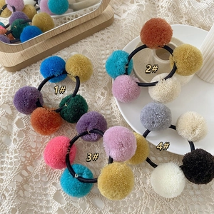 Colorful pom-pom hair ties with soft plush balls and elastic bands for women and girls