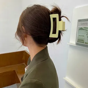 Elegant rectangle matte sage green claw clip for thick hair shown on a model